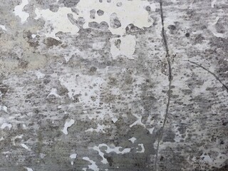 Intense gray grunge texture with peeling white paint and cracks