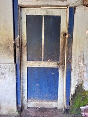 Old Distressed Blue Wooden Door And Grungy Wall
