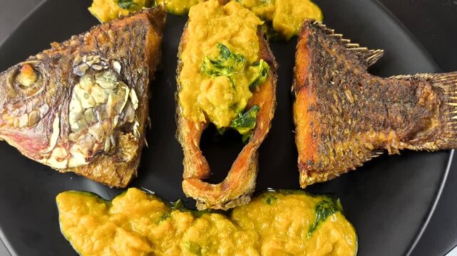 Deep-fried tilapia fish with pumpkin sauce, indoor Chiangmai Thailand.