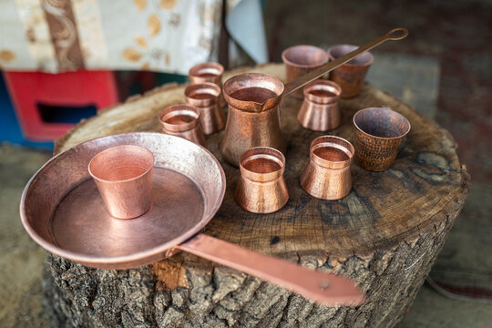 Roma coppersmith craft presenting traditional handmade copper pots, pans, and cups, showcasing artisanal skills from romania