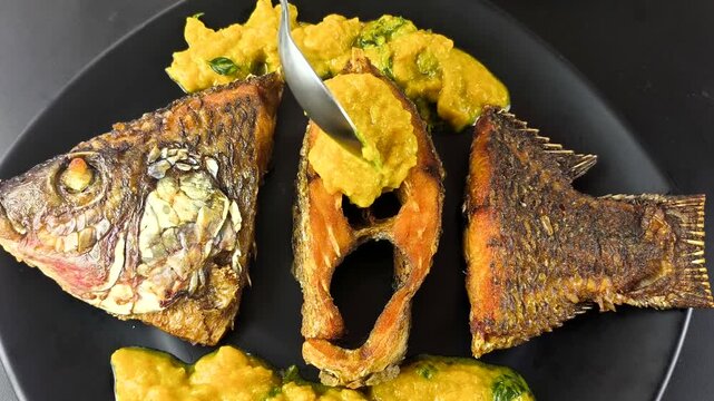 Deep-fried tilapia fish with pumpkin sauce, indoor Chiangmai Thailand.