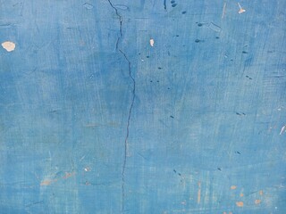 Vertical Crack on Rough Bright Blue Grunge Wall