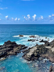 Rocky ocean coast with turquoise water and blue sky