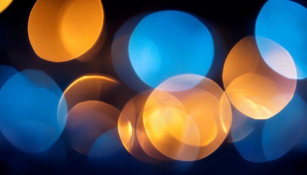 creative bokeh effect with bright circular light spots in warm yellow and cool blue tones glowing softly on dark background