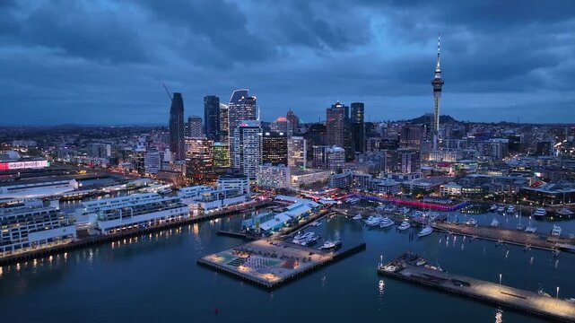 Panorama Flight through Auckland , New Zealand. Skyline. New Skyscrapers. Urban Canyon in Night Light. Aerial Pedestal in Establishing Night Drone Shot. Glowing street lights 