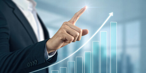 Businessman hand touching rising digital bar chart showing growth and success, professional gesture conveys confidence and progress