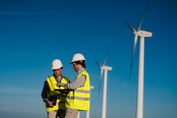 Engineers Inspecting Wind Turbine on a Sunny Day – Spain