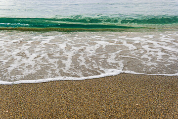 Foaming water and granular beach sand texture.