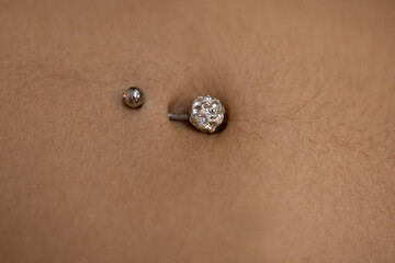 close-up of a woman's navel with a piercing