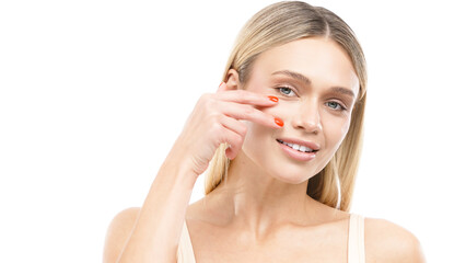 Fototapeta premium Beautiful young woman with clean fresh skin gently touching her face, showcasing a natural glow and healthy complexion, embodying beauty and self-care concept