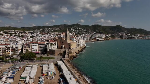 Drone orbit around Sitges city and church, Spain.