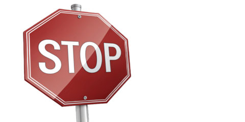 A close up view of a red stop sign with white lettering against a dark black background on a pole