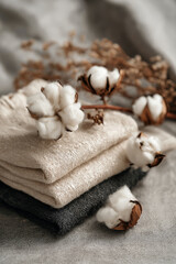 Soft cotton bolls placed on folded linen shirts, symbolizing natural textile materials and sustainable fashion craftsmanship