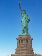 Statue of Liberty, the colossal American Icon and National Monument, standing against a brilliant Blue Sky