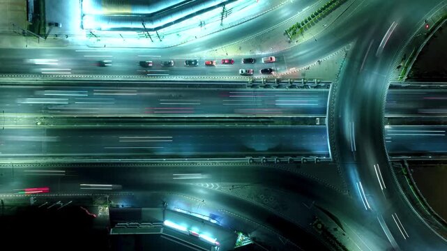 Expressway top view, Road traffic an important infrastructure, car traffic transportation above intersection road in city night, aerial view cityscape of advanced innovation, financial technology