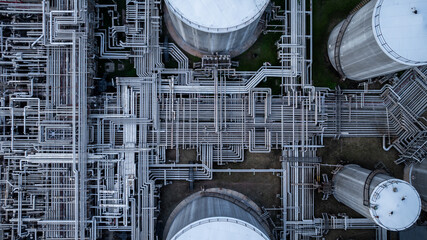 Aerial top view of oil and gas petrochemical storage tank and pipeline steel, Oil and gas transportation system pipeline steel at oil and gas refinery industry chemical plant, Pipeline oil and gas.