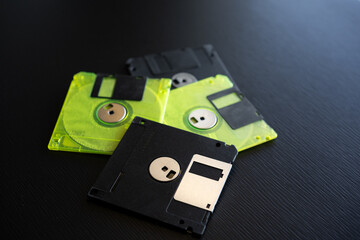 Fototapeta premium Vintage floppy disks scattered on a dark surface showcasing retro technology and data storage solutions