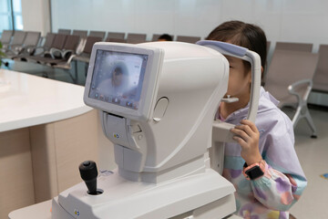 The little girl has her vision checked in the hospital