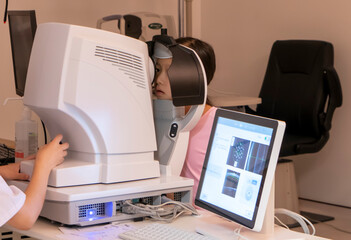 The little girl has her vision checked in the hospital