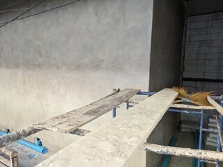construction autoclaved aerated concrete wall with rusted scaffold
