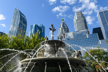 Berczy Park Dog Fountain and surrounding urban skyline cityscape of downtown Toronto, Ontario, Canada.