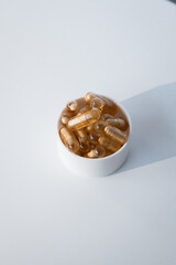 Golden vitamin capsules in glass bottle on white background
 
