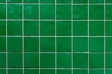 Green ceramic tile background. Old vintage ceramic tiles in green to decorate the kitchen or bathroom 