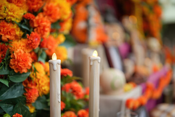 An artificial candle light with ancestor worship and group of decorated object on the table as...