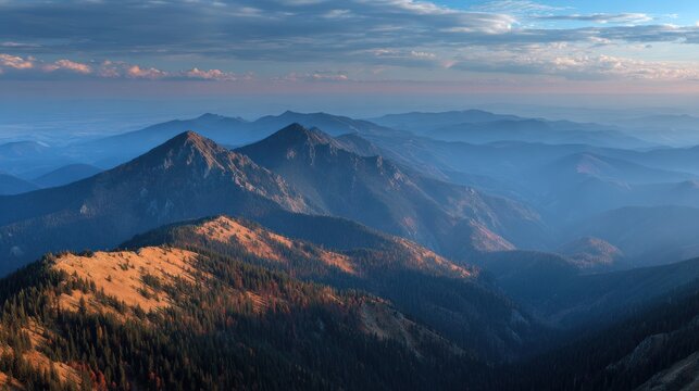 Majestic mountain range bathed in golden hour light with dramatic clouds at sunset