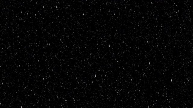 Realistic rain and snow particle overlay with soft falling streaks on green and black background. Seamless 4K loop texture for weather, cinematic or transparent visual effects