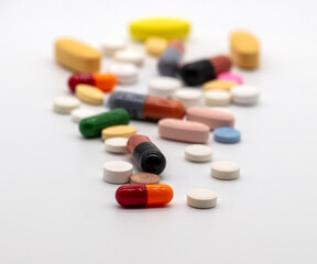 Medication, a variety of tablets pills and capsules on a white background