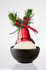 Christmas decoration on a bowl of rice on white background.