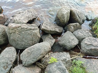 the collapsed masonry of the Swedish fortress lies on the riverbank
