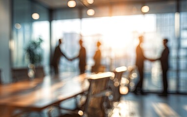 Silhouetted figures shake hands in a blurred sunlit office meeting room