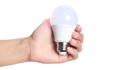 Futuristic Concept of Hand Grasping LED Light Bulb, Energy and Technology PNG