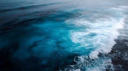 Dynamic ocean waves with vibrant blue water and white foam creating intricate natural patterns