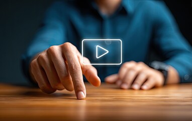 Person's finger touching a digital play button icon on a screen