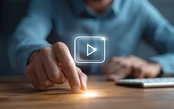 Person touching glowing play button on a digital screen