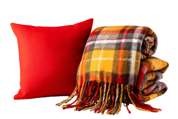 Cozy red pillow and warm plaid blanket with fringe on black background