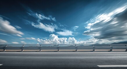 Open highway stretching into vast blue sky with dynamic clouds