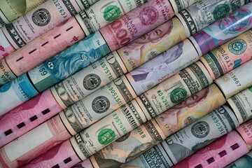 Currency exchange concept showing rolled banknotes from multiple countries representing global finance trade investment economy diversity and international monetary connection in world market