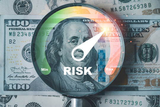 Financial risk concept showing a magnifying glass over US dollar bills with a risk gauge pointing to maximum level symbolizing investment danger finance uncertainty and market volatility