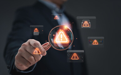 Spam and security concept showing a businessman holding magnifying glass focusing on digital warning symbol representing cybersecurity threat email protection alert and data risk in modern technology