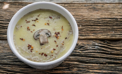 Creamy mushroom pate served in a white bowl on a rustic wooden table