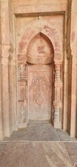 Intricately Carved Stucco Ceiling and Arches of Bada Gumbad Mosque in Delhi Showcasing Islamic Geometric Patterns and Calligraphic Art