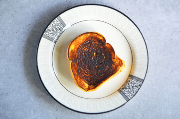 Top view of two slices of toasted white bread on a ceramic plate. Toast for breakfast.
