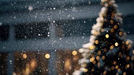 Snowy scene featuring a Christmas tree adorned with blurred golden lights with a backdrop of a house and falling snow