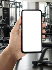Hand holding smartphone with gym background, fitness and workout concept, mobile fitness app or training tracker display, modern health and exercise technology idea, active lifestyle and motivation ph
