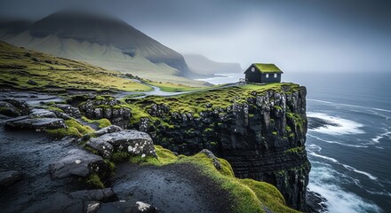 Isolated green grass covered house perched precariously on a dramatic cliff overlooking a stormy sea