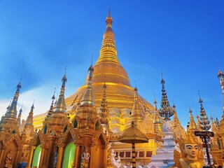 Naklejka premium Shwedagon Pagoda in Yangon Myanmar, Famous Golden Buddhist Temple Landmark with Blue Sky